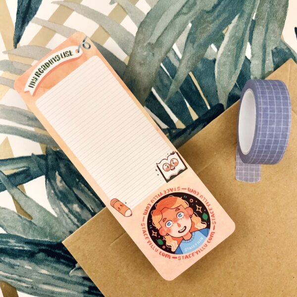 This image showcases washi tape, along with a peach bookmark and a reading list section to help you keep track of your progress.