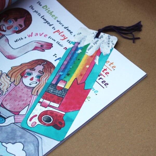 A book with a bookmark featuring a girl and a rainbow, along with a cute guinea pig named Super Poppy farting a rainbow. with a tassel.