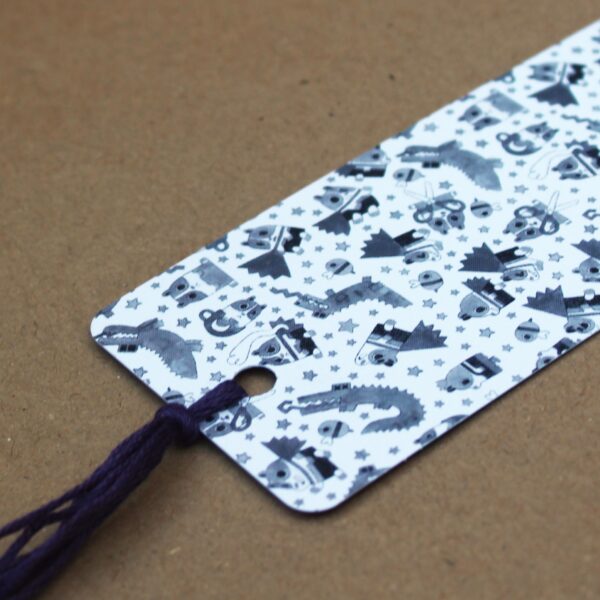 A cute super poppy bookmark with a purple tassle, perfect for adding a personal touch to any present.