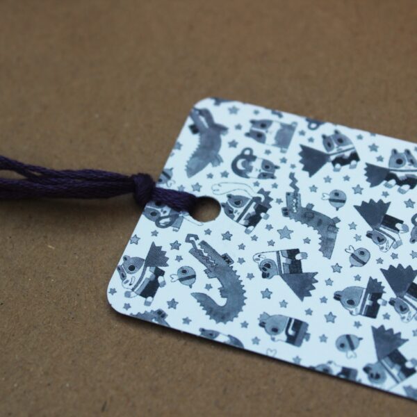 A cute super poppy bookmark with a purple tassle, perfect for adding a personal touch to any present.